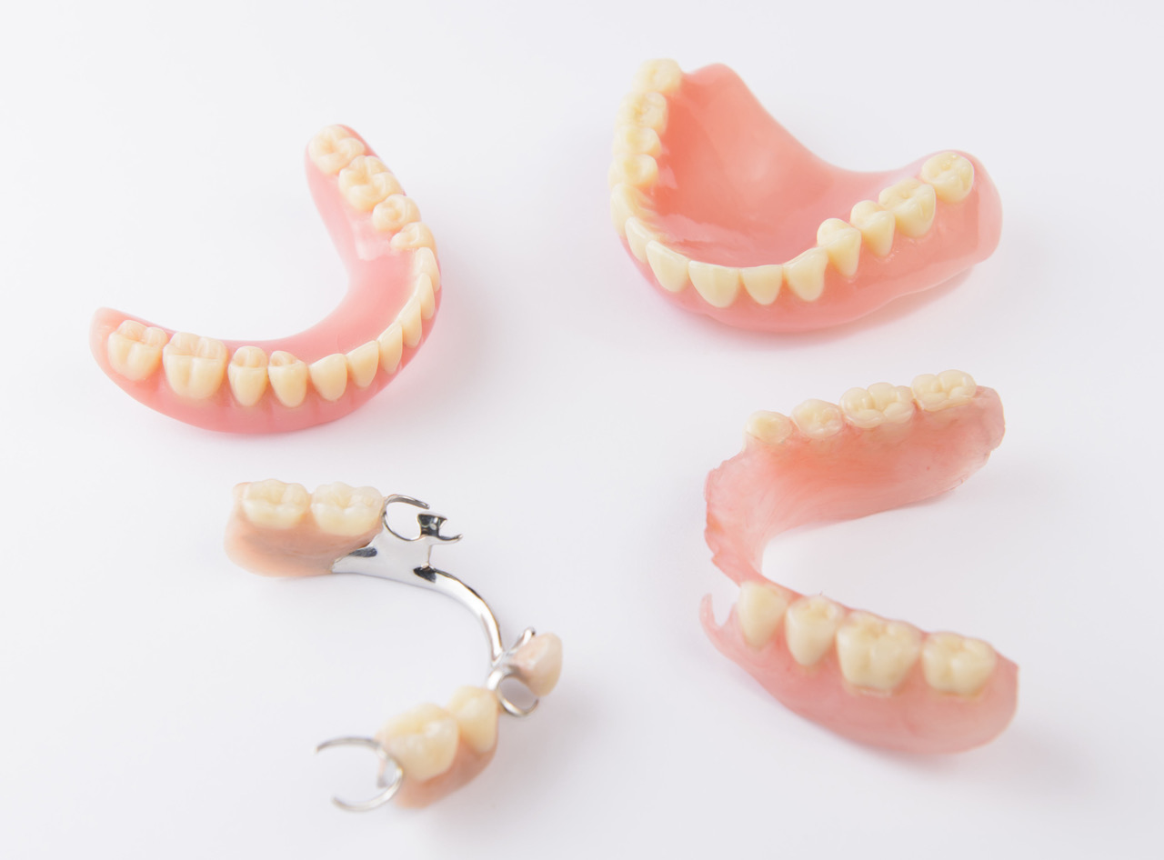 Group of dentures on white background Quick Straight Teeth